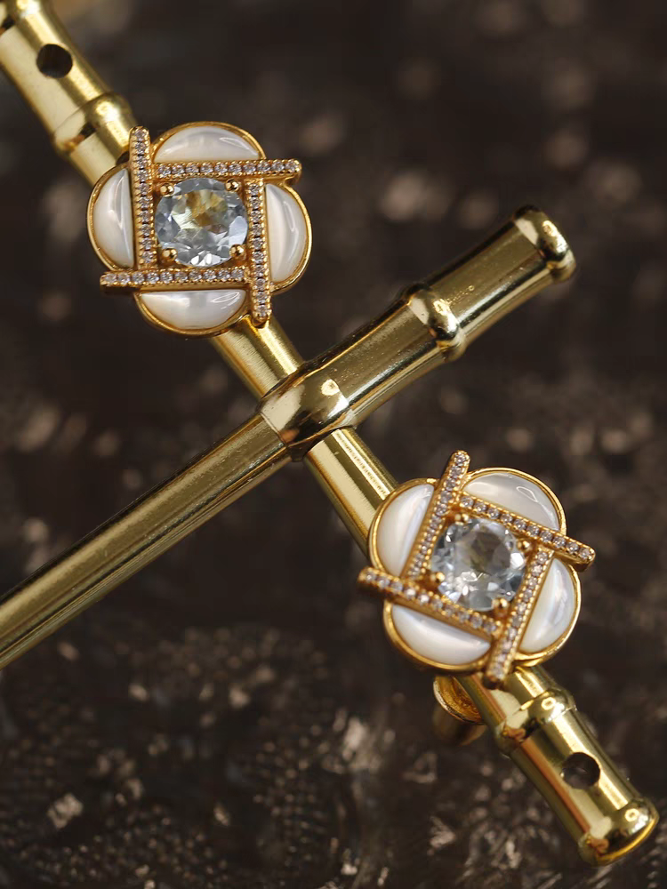 Clover Windmill Earrings – Gold-Plated Silver Mother-of-Pearl Studs with Sky Blue Topaz Accents